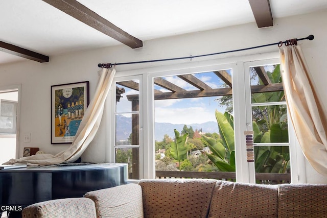 entryway with a mountain view and beam ceiling