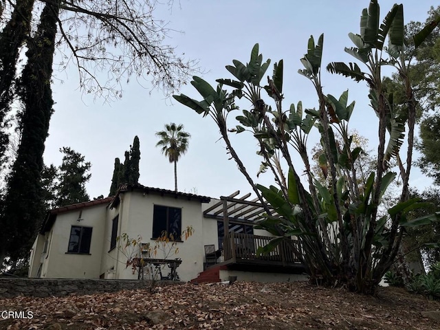 view of property exterior featuring a pergola