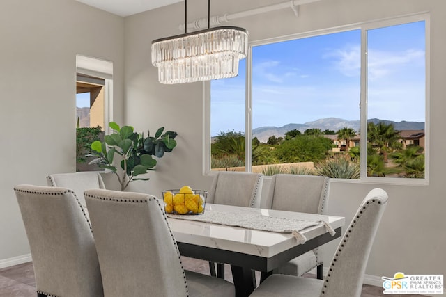 dining room featuring a mountain view and a chandelier