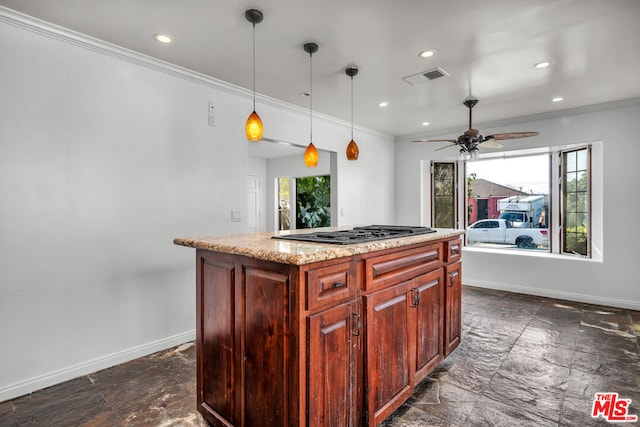 kitchen with pendant lighting, ornamental molding, stainless steel gas cooktop, and a kitchen island