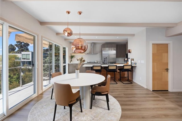 dining space featuring light wood-type flooring, baseboards, beam ceiling, and recessed lighting