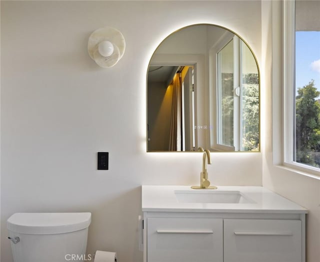 bathroom featuring vanity and toilet