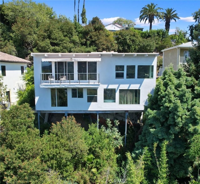 rear view of house featuring a balcony