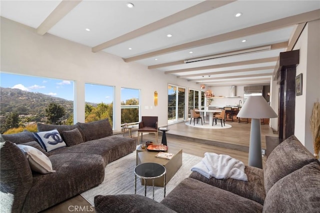 living room with recessed lighting, beamed ceiling, and wood finished floors