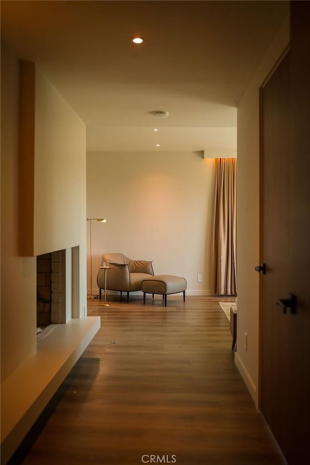 hallway featuring recessed lighting, baseboards, and wood finished floors