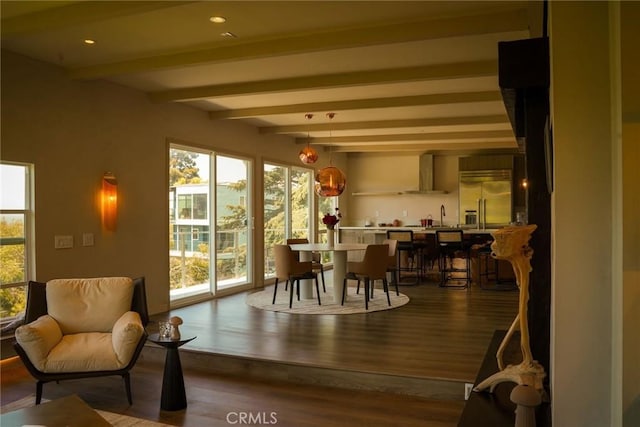 dining room featuring recessed lighting, dark wood finished floors, and beamed ceiling