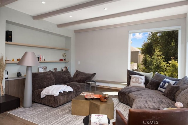 living area featuring recessed lighting, built in shelves, wood finished floors, and beamed ceiling