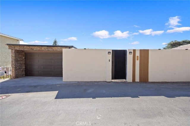 garage featuring a gate and fence