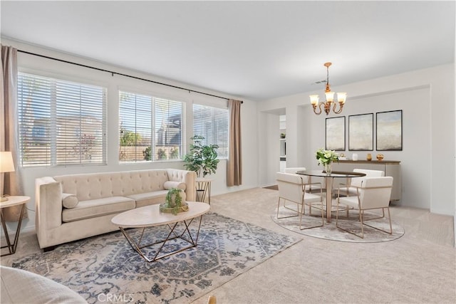 carpeted living area with visible vents and an inviting chandelier