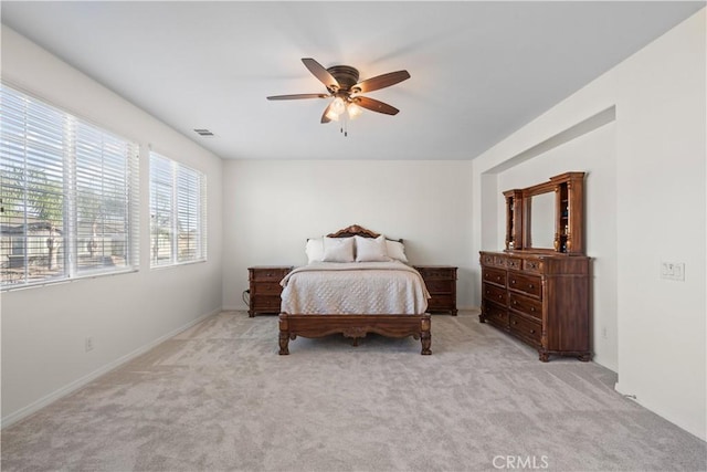 bedroom with a ceiling fan, light carpet, and visible vents