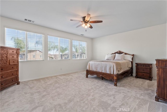 carpeted bedroom with visible vents, ceiling fan, and baseboards