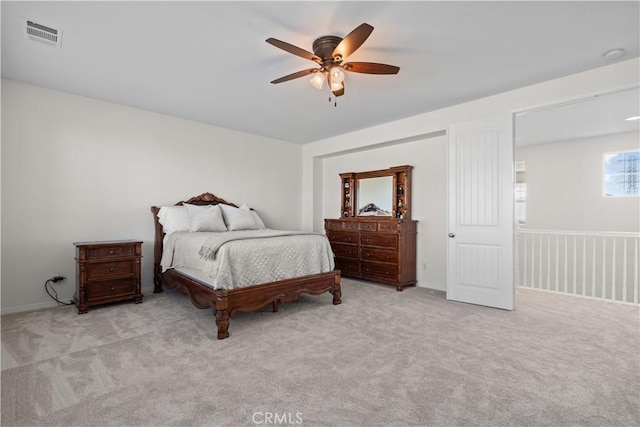 carpeted bedroom featuring ceiling fan and visible vents