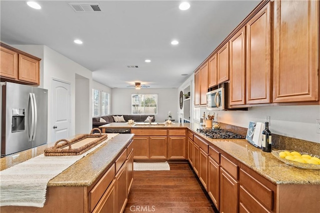 kitchen featuring recessed lighting, dark wood-type flooring, a sink, visible vents, and appliances with stainless steel finishes