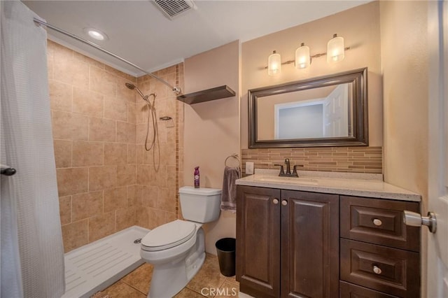 bathroom with tile patterned floors, toilet, vanity, a shower with shower curtain, and decorative backsplash