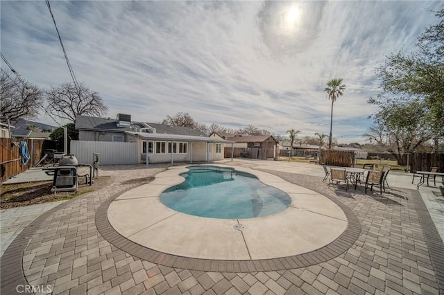 view of pool with cooling unit and a patio area