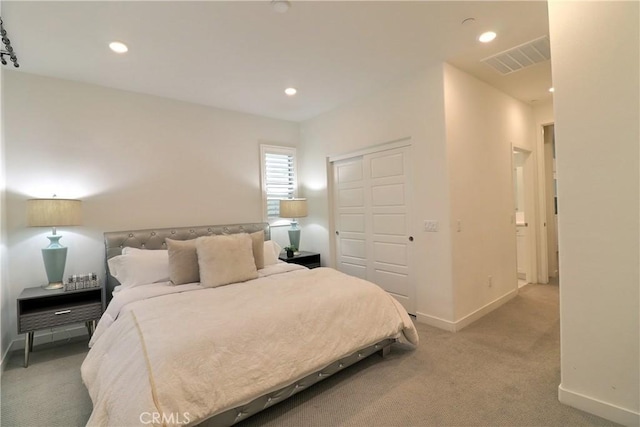 bedroom with light carpet, baseboards, visible vents, a closet, and recessed lighting