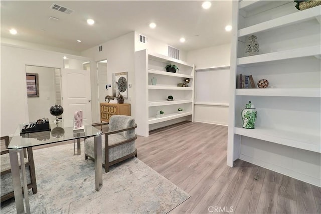 sitting room featuring light wood finished floors, visible vents, and recessed lighting