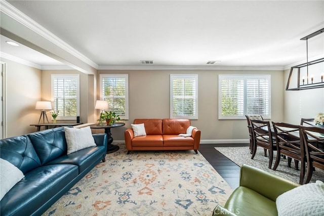 living room featuring ornamental molding, hardwood / wood-style floors, and a wealth of natural light