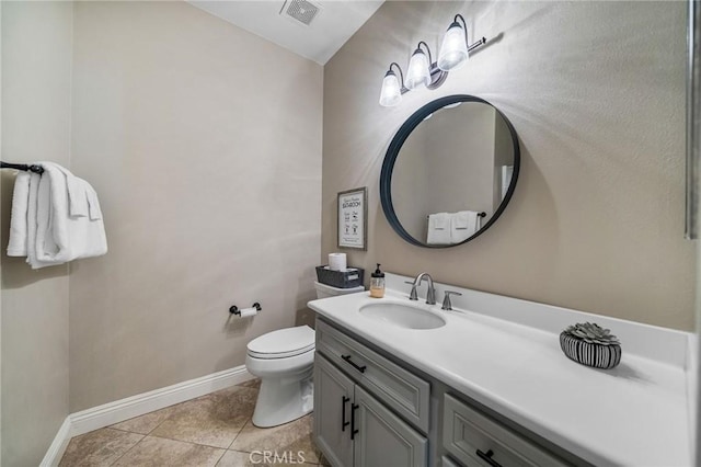 bathroom featuring vanity, tile patterned floors, and toilet