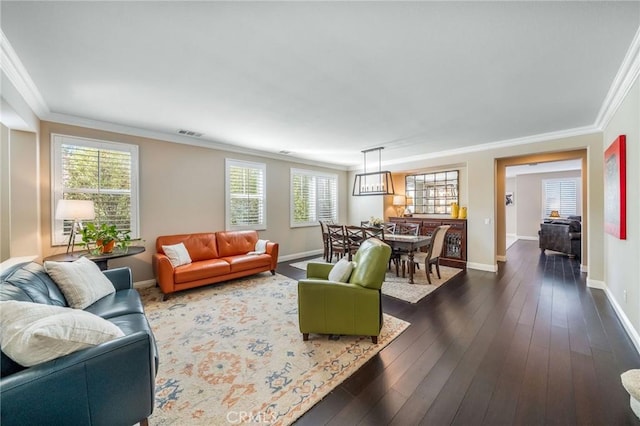 living room featuring dark wood-type flooring and ornamental molding