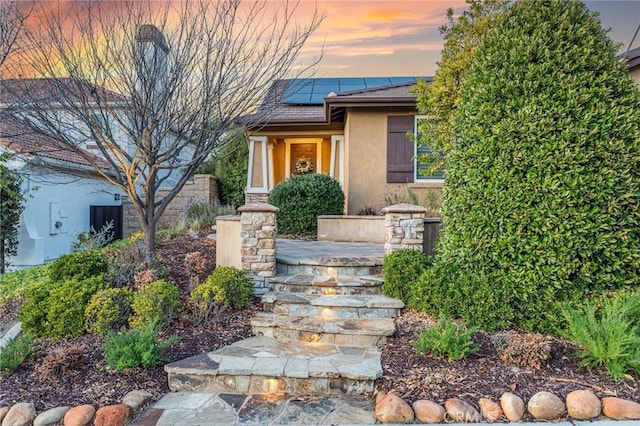 exterior entry at dusk with solar panels