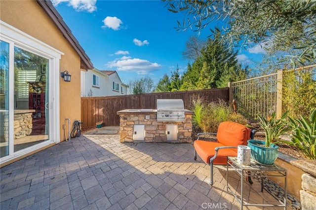 view of patio featuring area for grilling and exterior kitchen