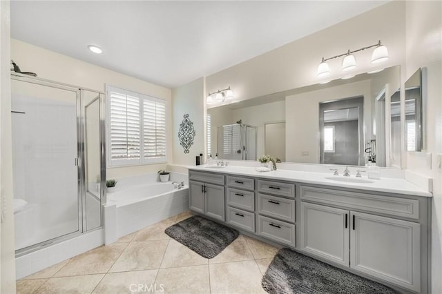 bathroom with tile patterned flooring, vanity, and separate shower and tub