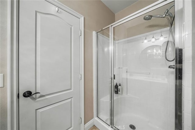 bathroom with a shower with shower door