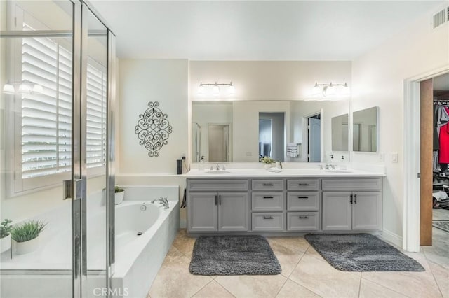 bathroom featuring tile patterned flooring, vanity, and separate shower and tub