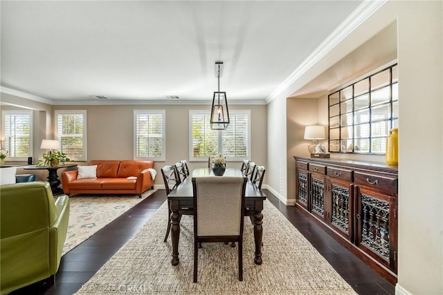 dining area with crown molding and dark hardwood / wood-style floors