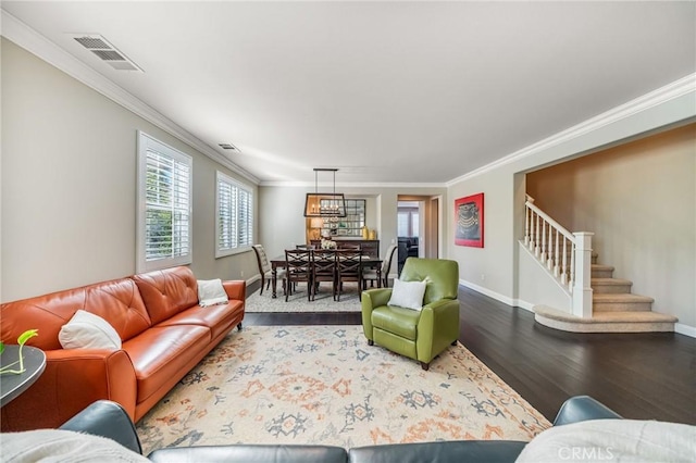 living room featuring wood-type flooring and ornamental molding