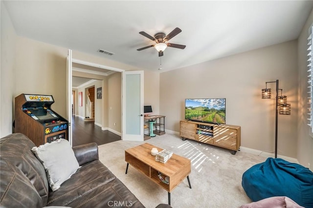 living room featuring ceiling fan and carpet