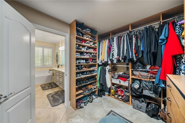 spacious closet with light tile patterned floors