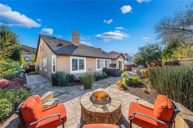 back of house with a patio area and an outdoor fire pit