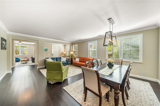 dining area with crown molding and dark hardwood / wood-style floors