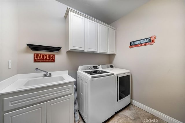 clothes washing area with cabinets, washer and clothes dryer, sink, and light tile patterned floors