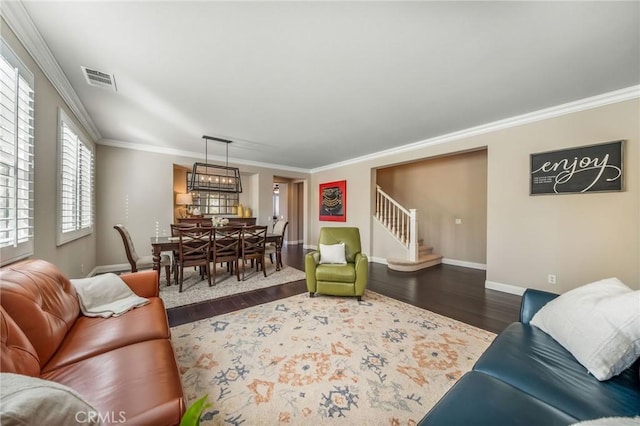 living room with hardwood / wood-style flooring and crown molding