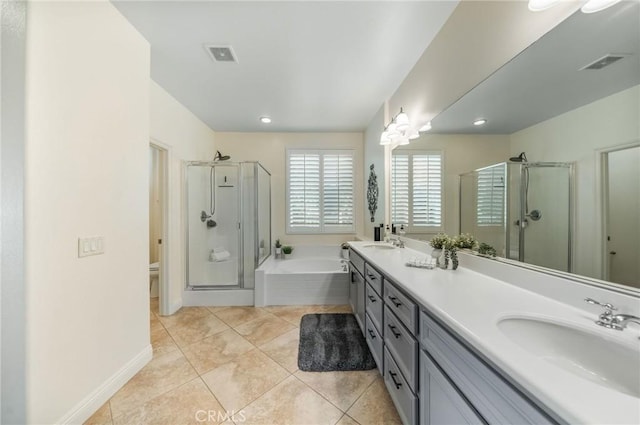 full bathroom featuring tile patterned flooring, shower with separate bathtub, vanity, and toilet