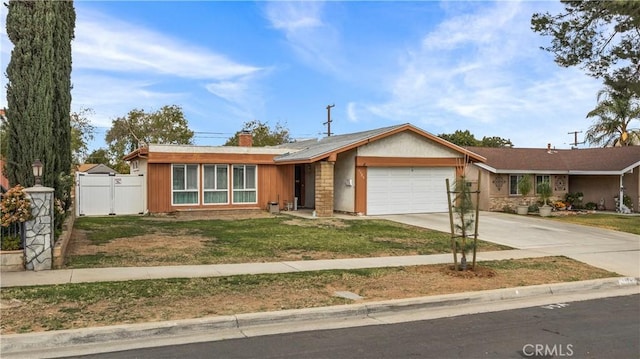 ranch-style home featuring a garage and a front lawn