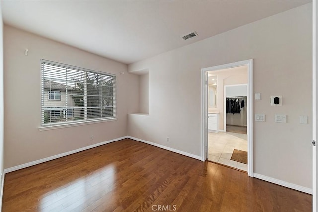 unfurnished room with dark hardwood / wood-style floors