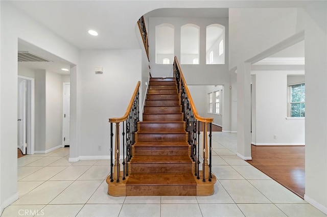 staircase featuring tile patterned floors