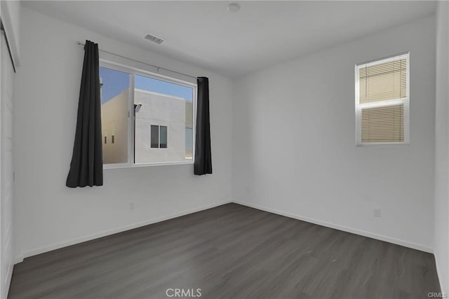 spare room with dark hardwood / wood-style floors