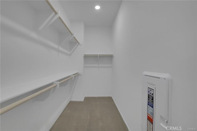 spacious closet featuring dark carpet