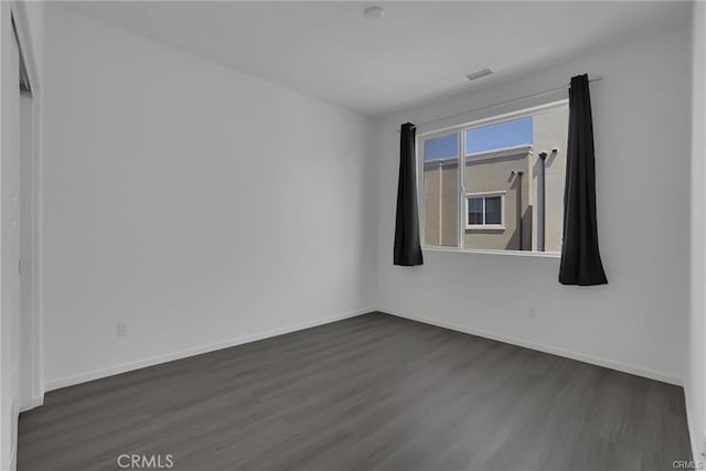 empty room featuring dark hardwood / wood-style flooring