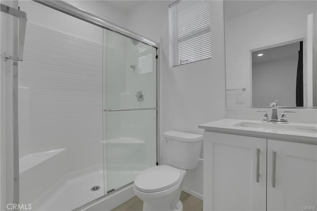 bathroom with vanity, toilet, and an enclosed shower