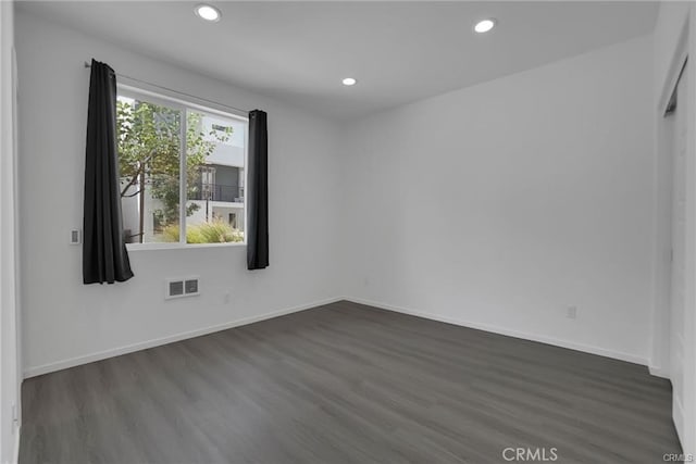 unfurnished room with dark hardwood / wood-style floors