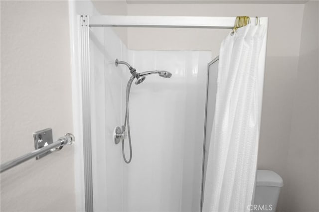 full bath with a shower stall and toilet