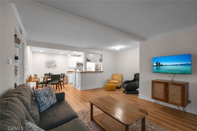 living area with wood finished floors and baseboards