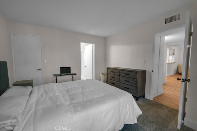 carpeted bedroom featuring baseboards and visible vents