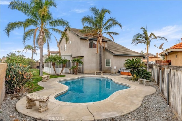 view of pool with a hot tub and a patio